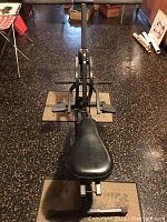 Top view of the Sport Rider exercise machine showing the padded seat, foot pedals, and metal frame structure.