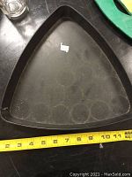 Top and side view of the black Glenfidditch branded pool ball rack showing triangular shape and used condition with scratches.