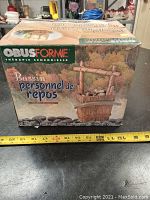 Photo of the top of the box showing the front-facing brand Obus Forme and product name Bassin personnel de repos (Personal Calming Pond) with product image and packaging condition.