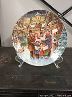 Front view of Stewart Sherwood collector plate depicting Victorian Christmas carolers with detailed colorful winter scene.