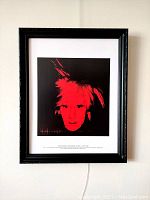 Framed lithograph print hung on a wall, showing the full artwork and frame.