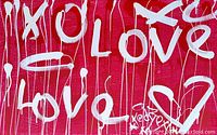 Partial close-up showing white 'Love' lettering and drips on red background