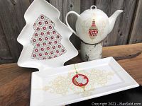 All three Maxwell Williams Christmas serving pieces arranged together: Baubles teapot, Baubles rectangular platter, Garland tree-shaped platter.