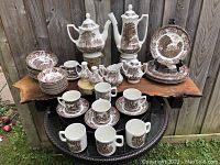 Wide shot of entire 52-piece set arranged on table outdoors