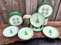 Two vintage boxed sets of Boston Warehouse Damask Trees porcelain plates featuring 4 unique Christmas tree designs per set.