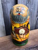 Close-up of the Father Time large matryoshka doll showing clock, beard, glasses, and handpainted details.