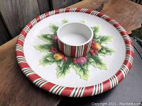 Top angle photo showing full chip and dip bowl with candy cane rim and central dip section, festive holly and fruit garland decoration.