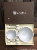 Photo of Henriette branded box open showing white double-section bowl and six olive picks in original packaging.