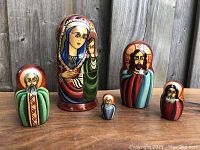 Full view of all five nesting dolls arranged in size order showing entire set with Mary holding Jesus, Joseph, and three wise men.