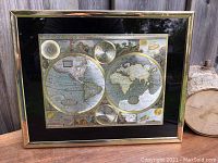 Framed Bleau two-hemisphere map showing detailed geographical and artistic elements with gold foiling.