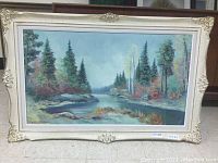 Full view of framed landscape painting showing the overall composition and vintage frame details.