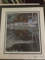 Full view of framed print showing three deer by a pond in winter with reflections and icicles