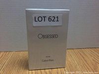 Front view of the sealed white box containing Calvin Klein Obsessed Eau de Toilette for Men with label LOT 621