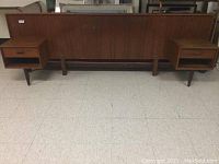 Full front view of teak headboard with integrated side tables