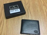 Closed black leather wallet with Sullinni logo on front, next to the branded box.