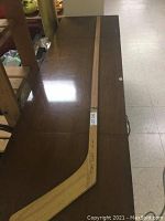 Full view of wooden hockey stick laid on table