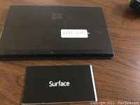 Closed Surface tablet with protective case and instruction booklet