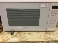 Front view showing the white Panasonic microwave, model with vented door.