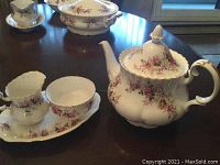 Full view of teapot with creamer and sugar bowl on oval tray showing the Lavender Rose floral pattern and gold accents.