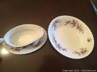 Two oval serving dishes side by side displaying Lavender Rose floral clusters and scalloped edges with gold trim.