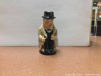 Front angle view of the Royal Doulton Winston Churchill character jug showing detailed facial features, hat, and coat.