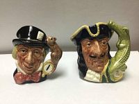 Front view of both Royal Doulton Toby character jugs showing faces and details