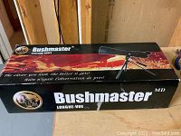 Box of Bushmaster spotting scope showing branding and product image with desert background.