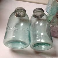 Pair of aqua Imperial brand quart jars with metal lids embossed 'Imperial'