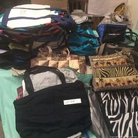 Various canvas and patterned bags, including animal print totes and a woven jute bag, in a pile showing condition and size variety
