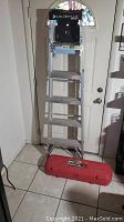 Louisville aluminum step ladder model W2213-06S shown in an indoor setting from front view with door background.