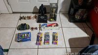 Wide view of all Star Wars collectibles including mechanical Darth Vader figure, packaged figures, and various loose figures and toys.
