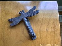 Top down view of dragonfly door knocker showing detailed wings and body