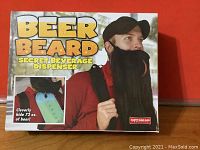 Front view of the Beer Beard Secret Beverage Dispenser box showing product name, image of man wearing the beard, and claim that it holds 72 oz. of beer.