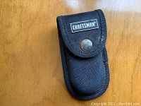 Front view of the black nylon Craftsman multitool holster with snap button