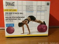 Front of the unopened box showing Everlast Pro Grip Fitness Ball, textured surface, 65 cm size, and exercise usages.