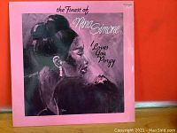Front cover of The Finest of Nina Simone LP with pink background and profile illustration of Nina Simone
