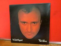 Front cover of the vinyl album showing close-up image of Phil Collins face, album title and artist name