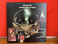 Front album cover showing concert crowd with Three Dog Night band photos and track listing.
