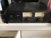 Front view of black Realistic Stereo Power P.A. Amplifier MPA-100 with dual VU meters, power switch, speaker selectors, and control knobs.