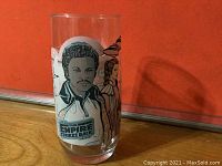 Clear glass tumbler with image of Lando Calrissian from Star Wars The Empire Strikes Back and Burger King collectible branding