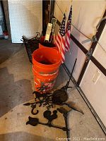 Overview of orange buckets, various fireplace tools, American flags, and handheld levels.