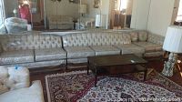 Full front view of three-piece sectional in room with Persian rug and coffee table