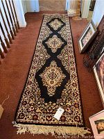Full view of Sears Dynasty Classic runner rug laid on a brown carpeted floor, showing overall design and condition.