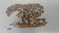 Full view of the Asian themed metal wall art showing two figures under a detailed tree with foliage and flowers.