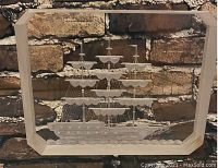 Large rectangular glass paperweight with engraved sailing ship under glass, displayed in front of textured background.