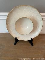 Front-facing view of the Lenox serving dish on a stand showing embossed leaves and gold rim detail