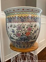 Full view of the large Famille Rose planter showing overall shape and main floral designs on the exterior.