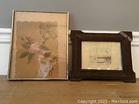 Two framed artworks displayed side by side: a painting on plastic with floral design and a dry point etching with marine scene.