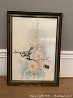 Full view of framed watercolor painting showing a bird on a branch with flowers and a bee