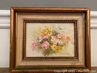 Full view of the framed oil painting showing the floral arrangement and overall frame condition.